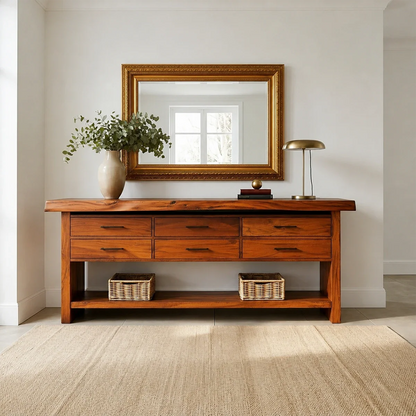 Wooden console table with a mirror, lamp, and decorative items in a room.