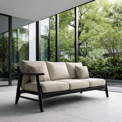Designer sofa with neutral upholstery and exposed wood frame placed in modern architectural space