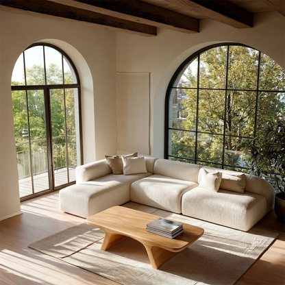 Sculptural coffee table featuring smooth top and curved support for contemporary spaces