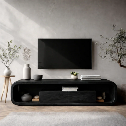 In this bright room, a curved edge media console offers storage and warm natural wood texture