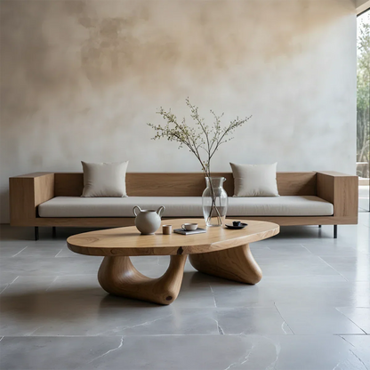 Oak coffee table with thick top and curved base design in a soft toned minimalist living room