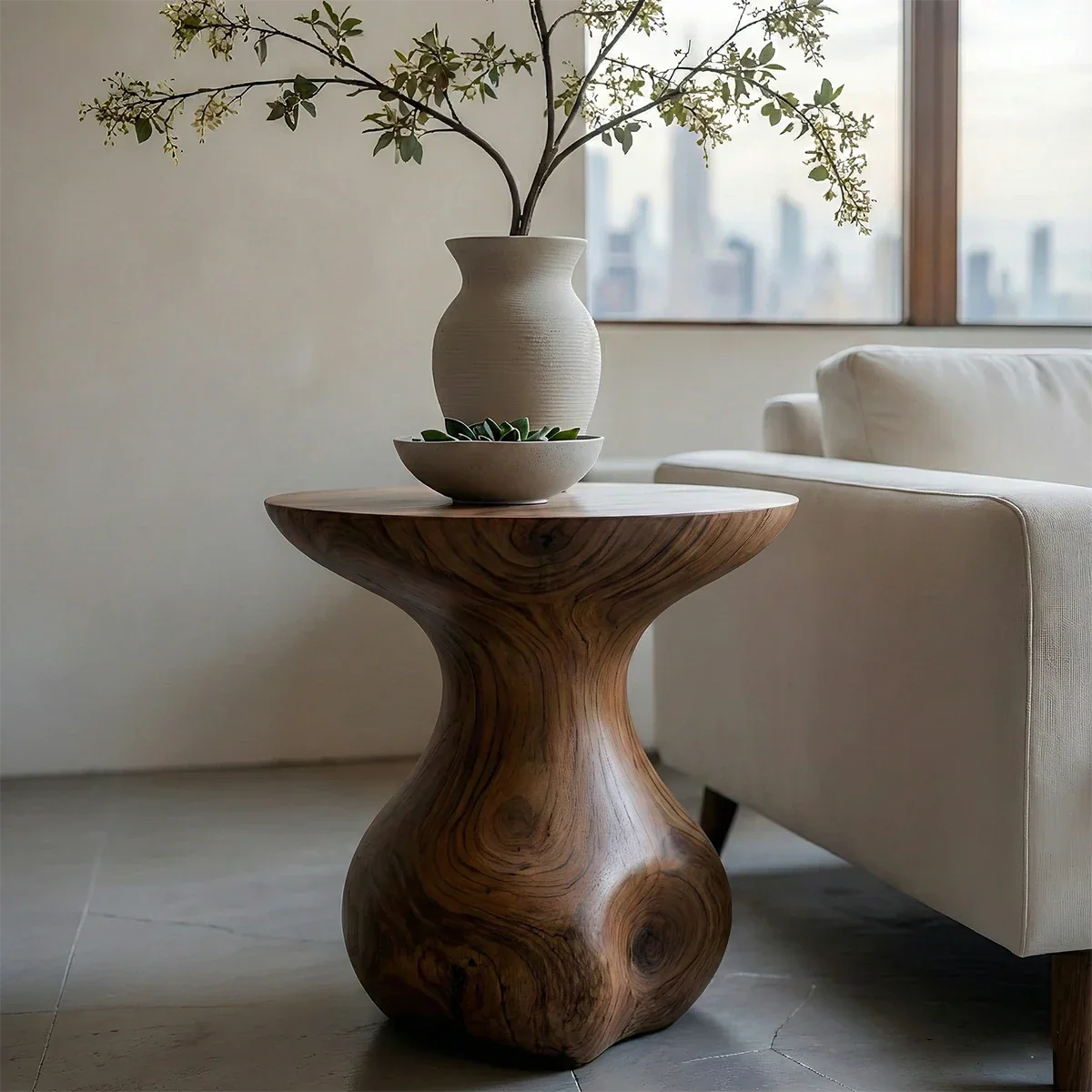 This walnut color accent table showcases a rounded silhouette and practical display space