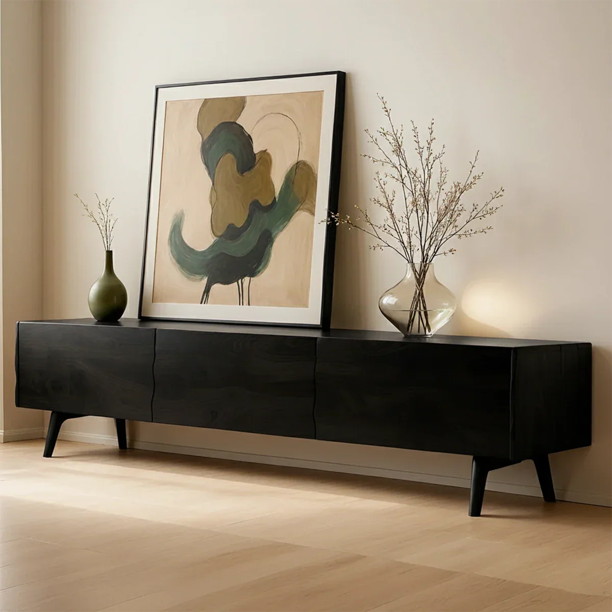 Black finish TV stand with low profile design and natural grain visual in a bright space