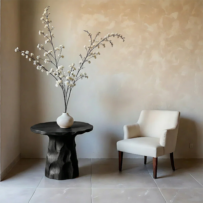 With its black color design, the accent table blends sculptural detail and organic shape